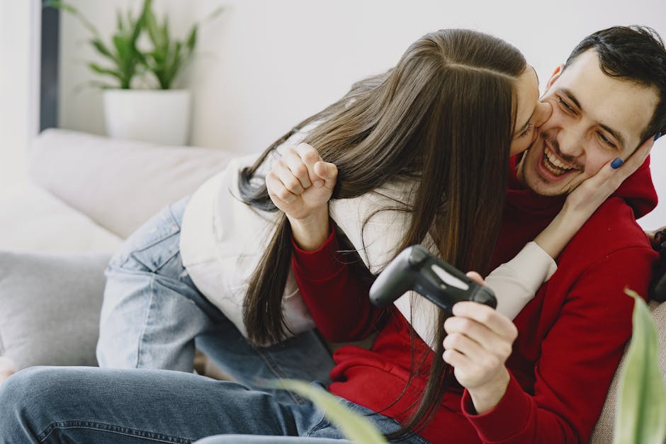 Photo of Man Smiling While Being Kissed by a Woman